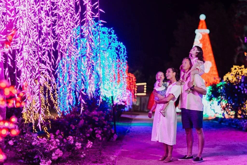 A family enjoying the Hunter Valley Christmas lights at the Hunter Valley Gardens