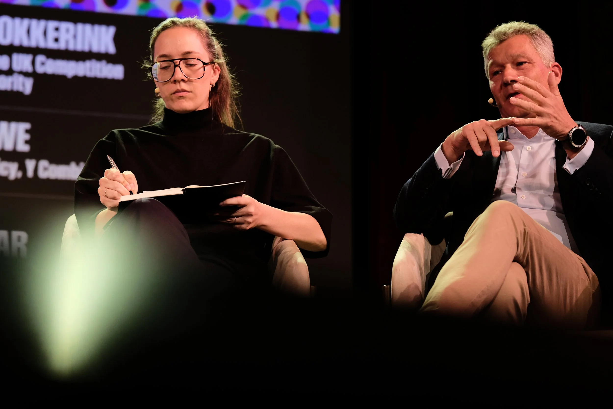 Vass Bednar, Managing Director of the Canadian SHIELD Institute, takes notes as she listens to co-panelist Marcus Bokkerink, former Chair of the UK Competition and Markets Authority.