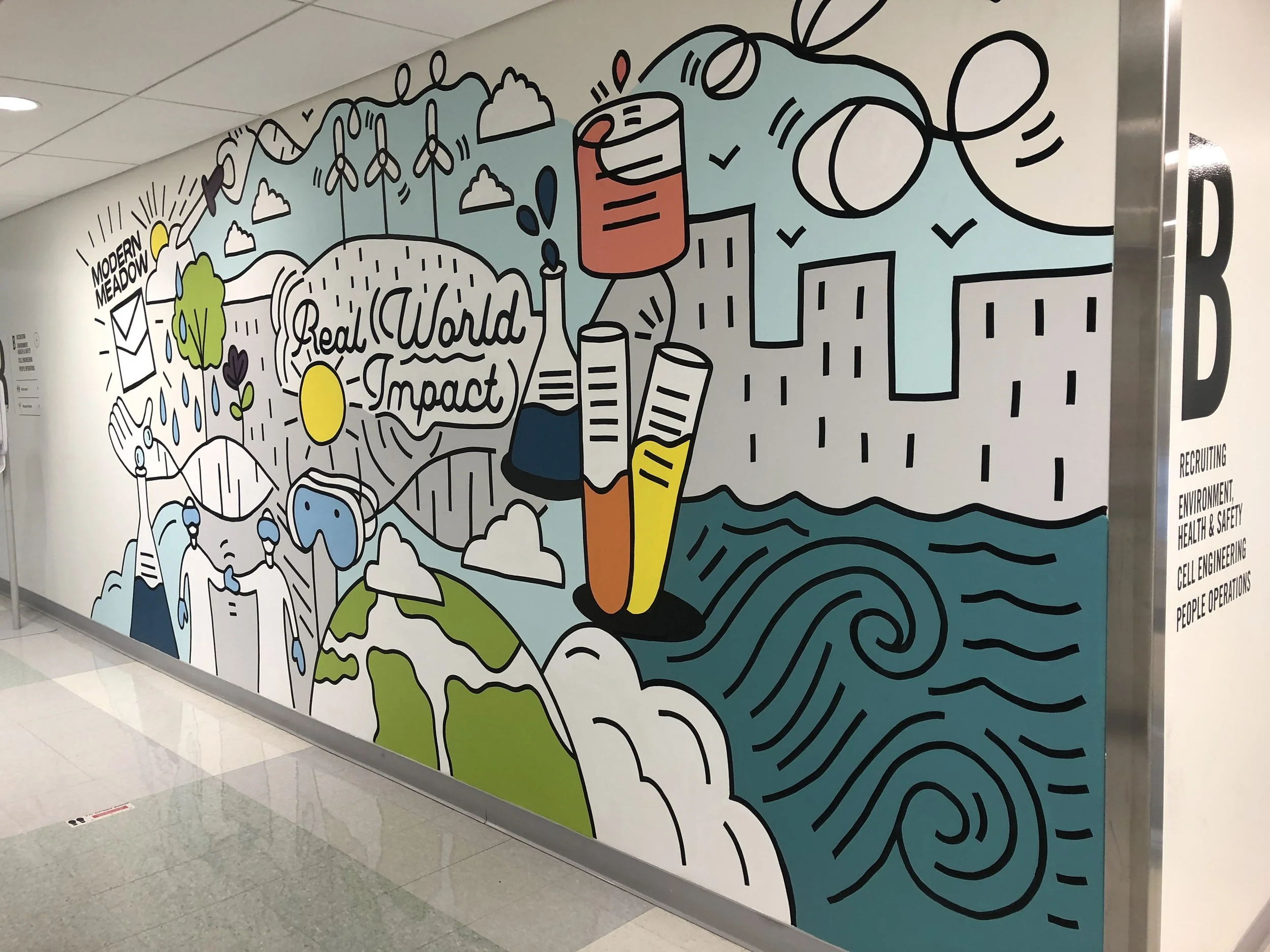 Colorful mural featuring nature themes, wind turbines, a sunrise, water, and the words 'Real World Impact' with a wave pattern in the background.