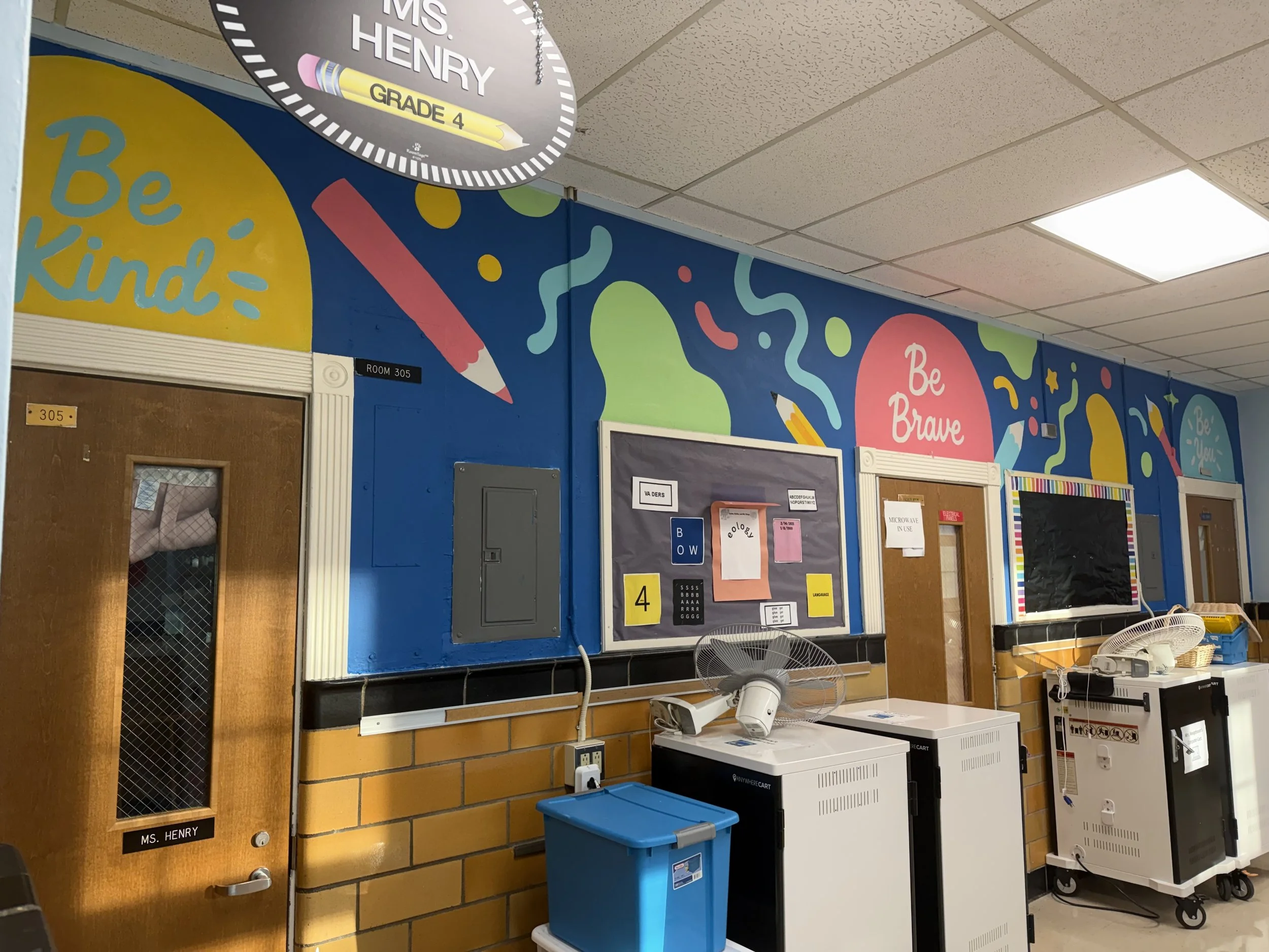 Colorful school hallway featuring custom murals and hand-painted educational artwork.