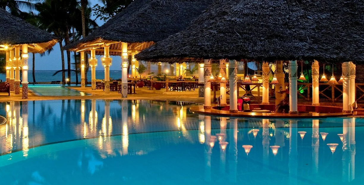 Neptune Village Evening View of Pool And Bars 2.jpg