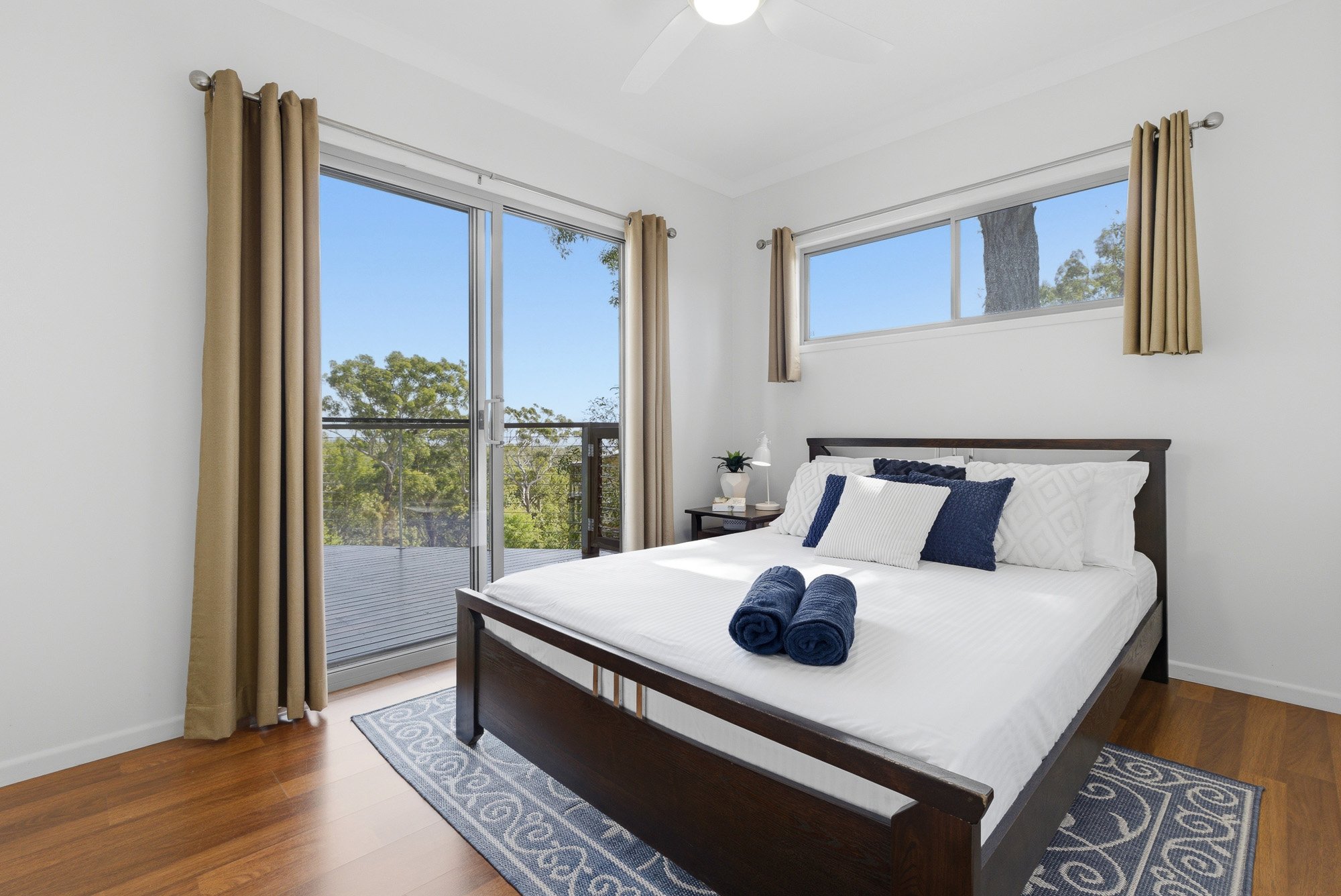 Lovely upstairs bedroom with direct deck access, offering a peaceful private space to relax after a day exploring Fraser island K’gari.