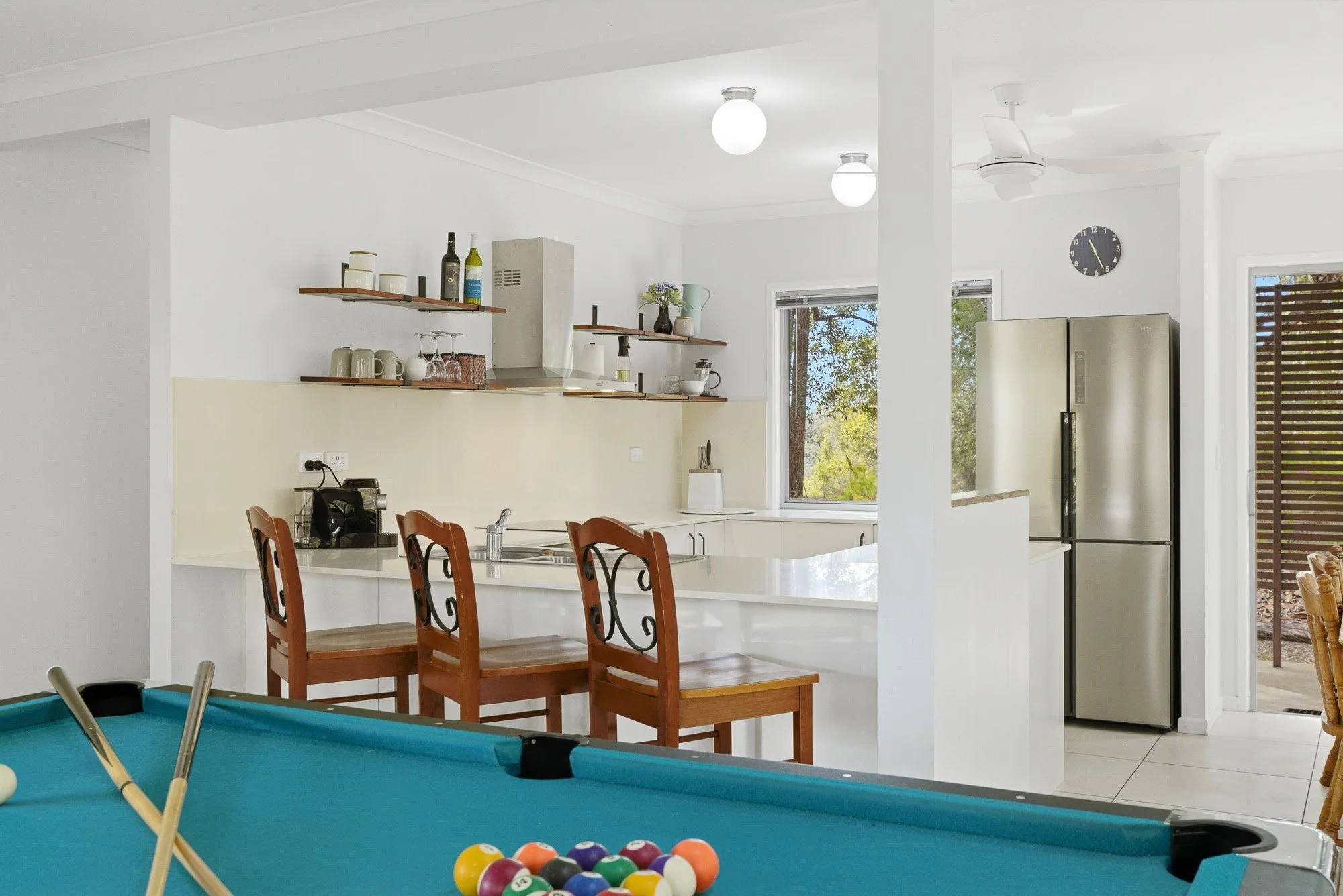 Open-plan living with a full kitchen, dining area and pool table, flowing straight onto the outdoor BBQ and alfresco dining space — made for long lunches, shared dinners and relaxed island evenings together.