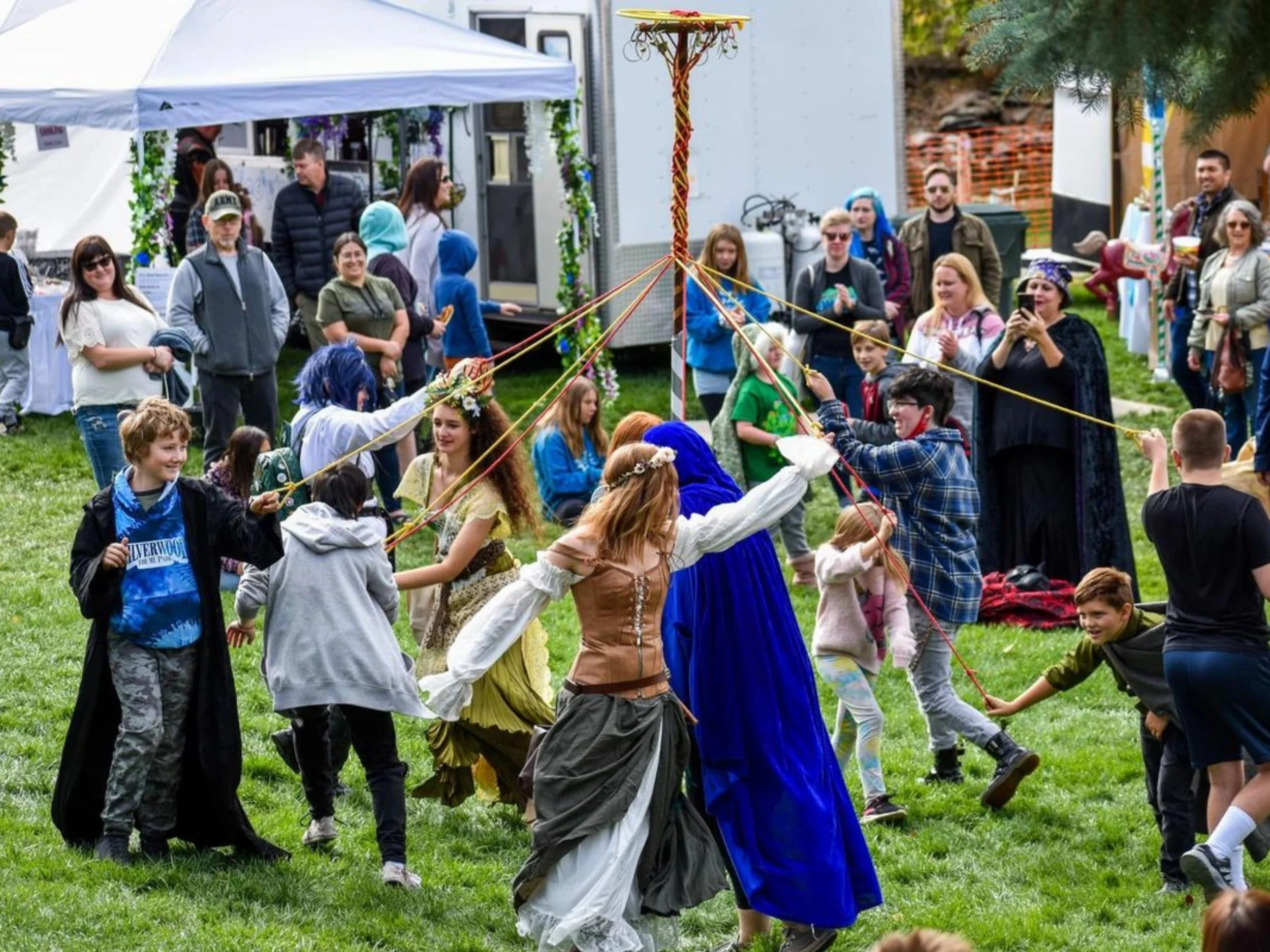 People dancing a traditional MayPole Dance