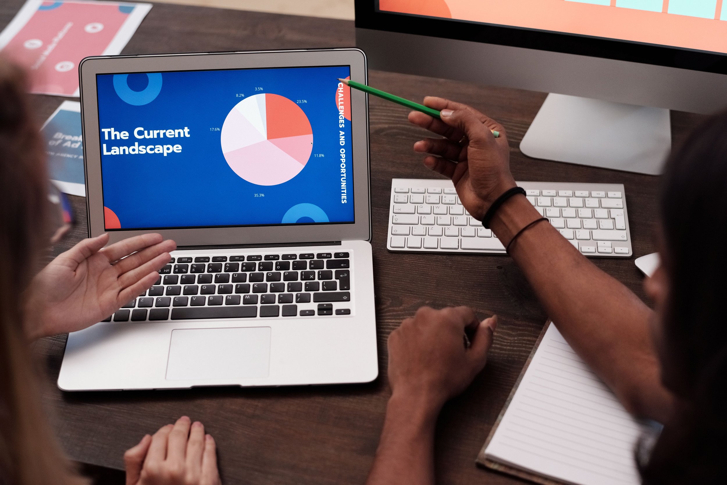 Marketing analysts reviewing forecast data and projected performance trends