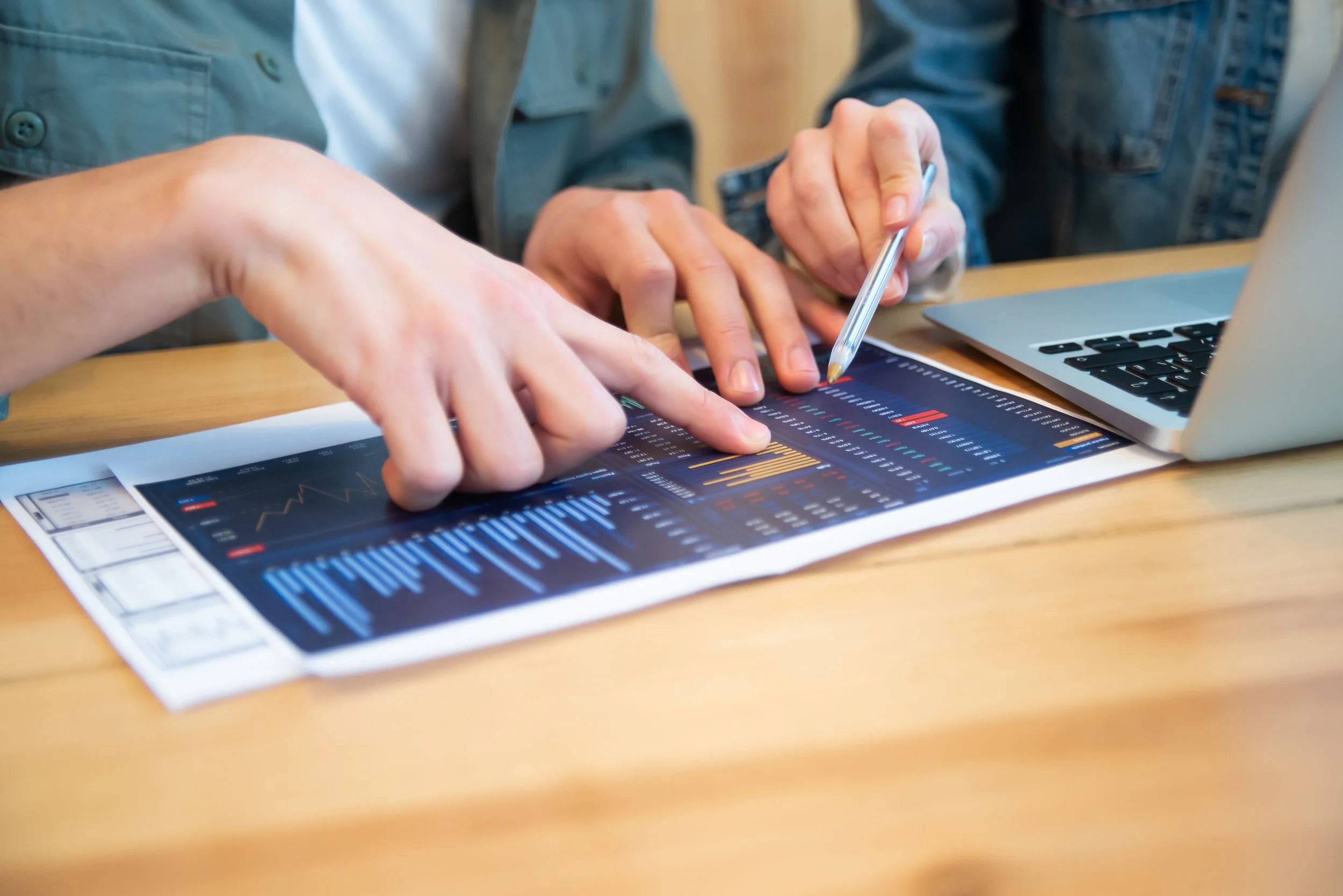 Business professionals using analytics reports to support data-driven marketing decisions