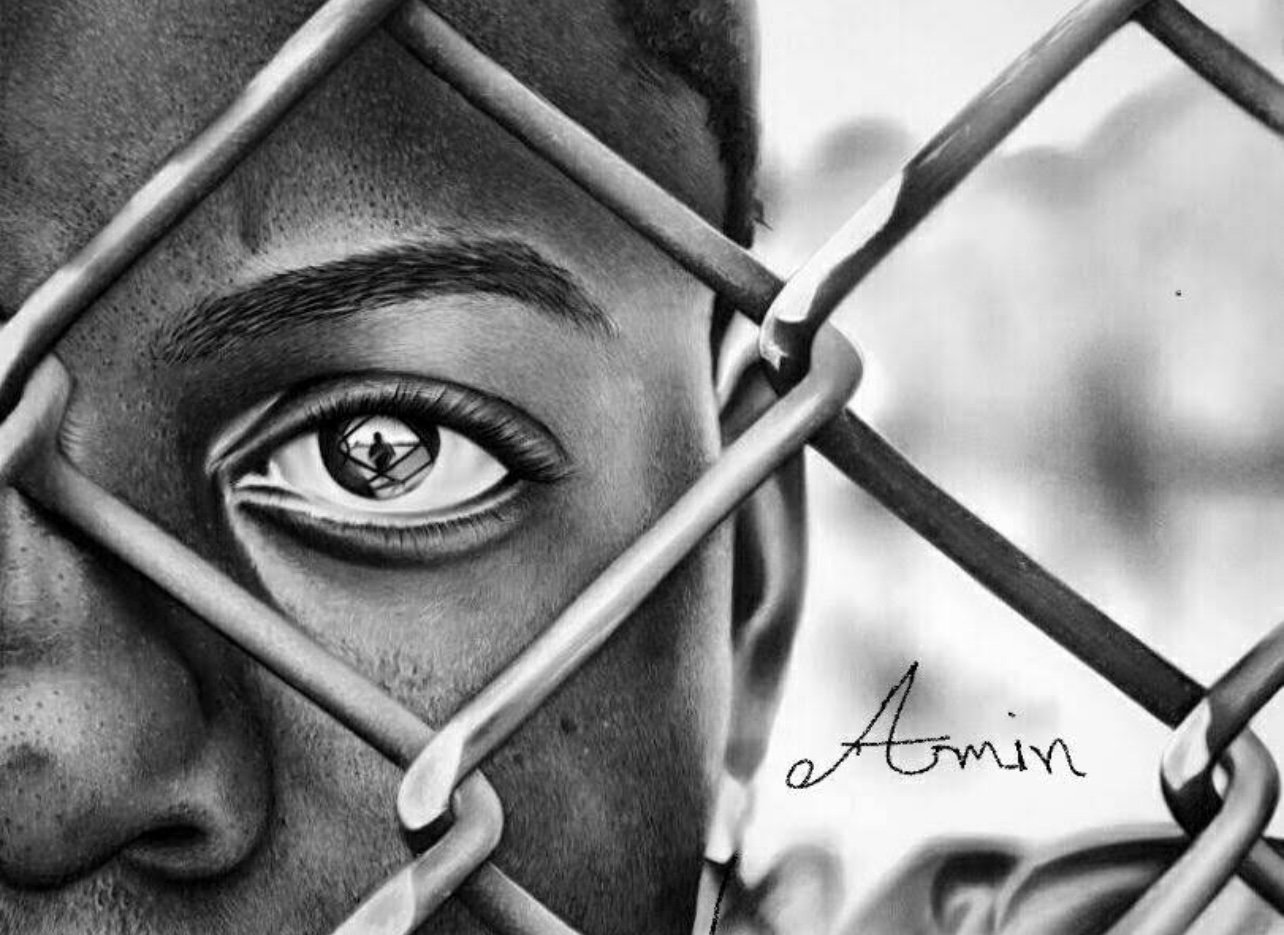 Black and white drawing of a close-up face behind a chain-link fence, with a reflective eye showing a silhouette. Artist signature 'Amin' visible.