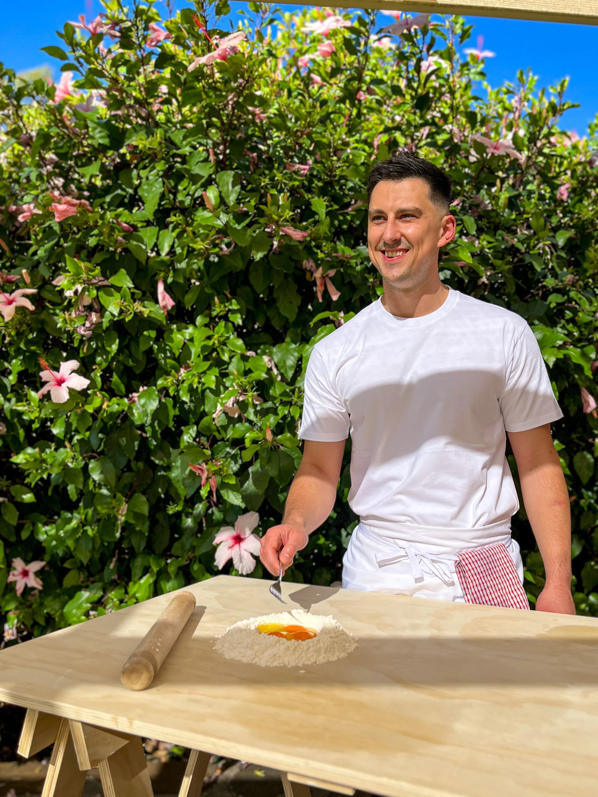 Chef Nick Tadija, founder of Daje One Adelaide cooking school, cooking in his kitchen