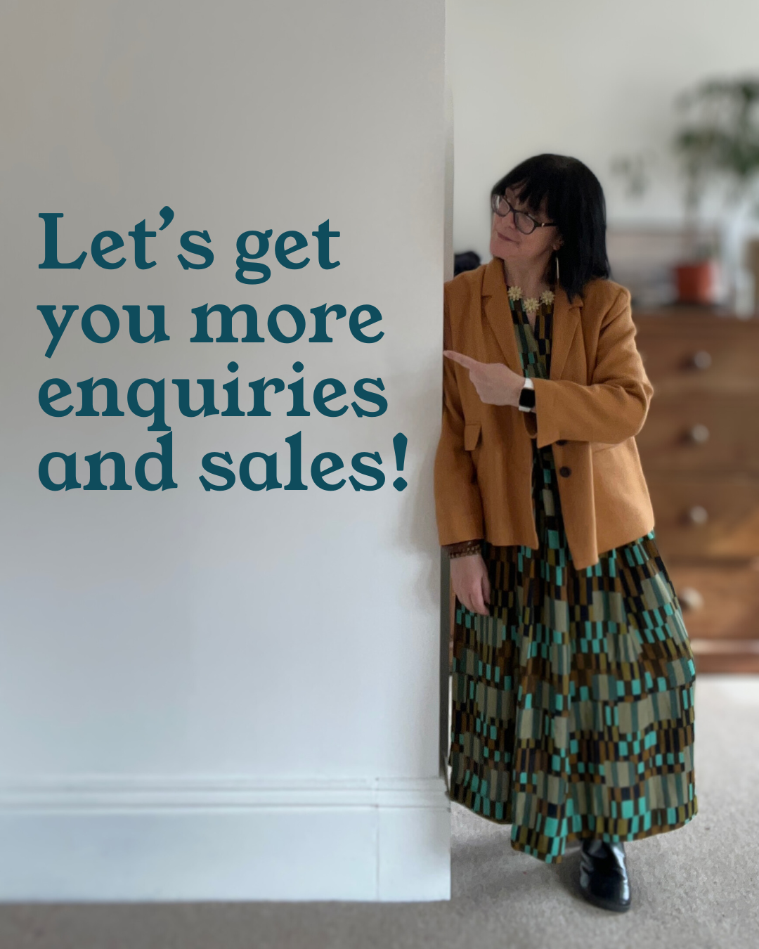 Digital marketer Sarah pointing to a sign saying 'Let's get you more enquiries and sales'