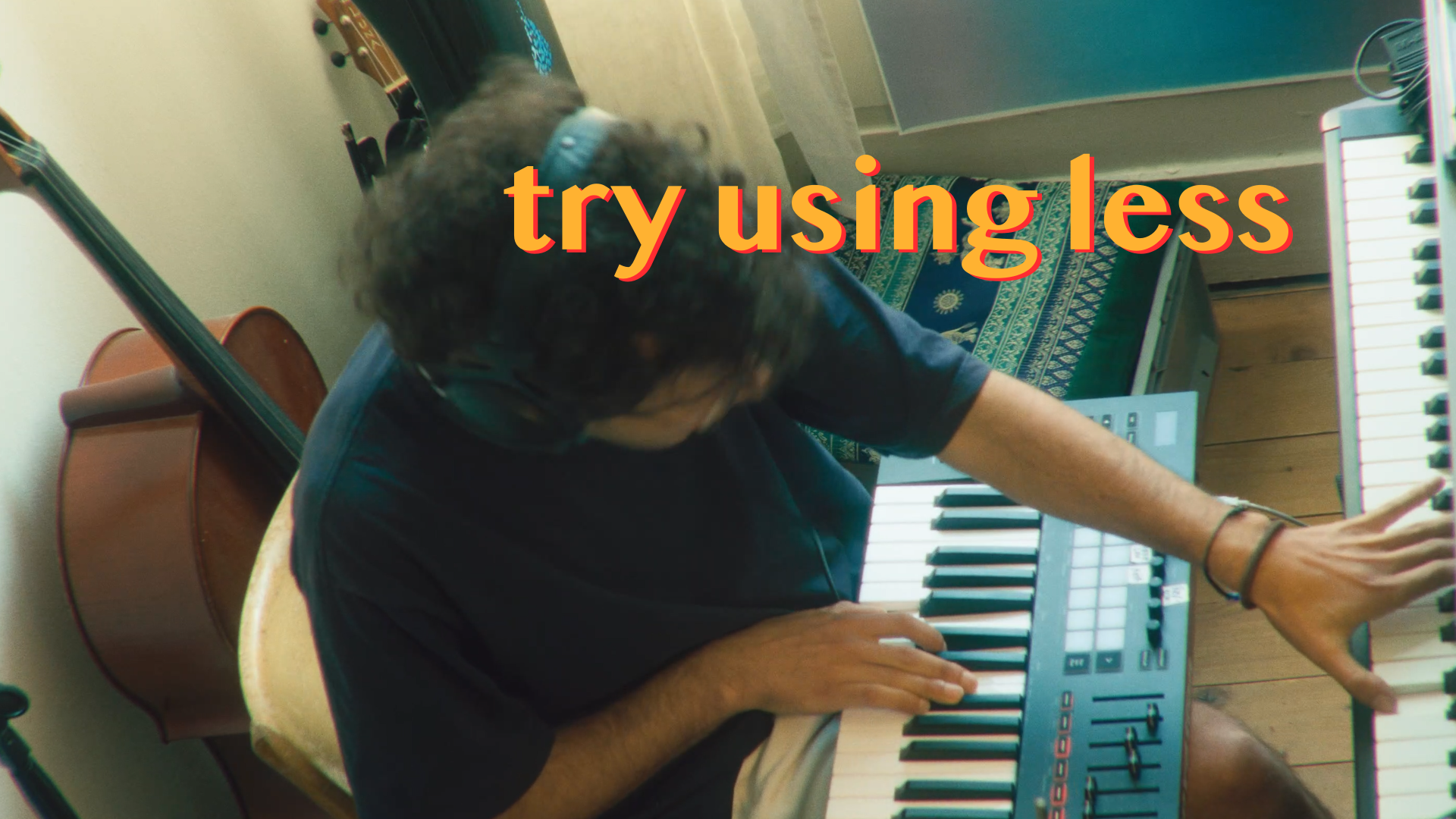 Person playing keyboard with "try using less" text overlay