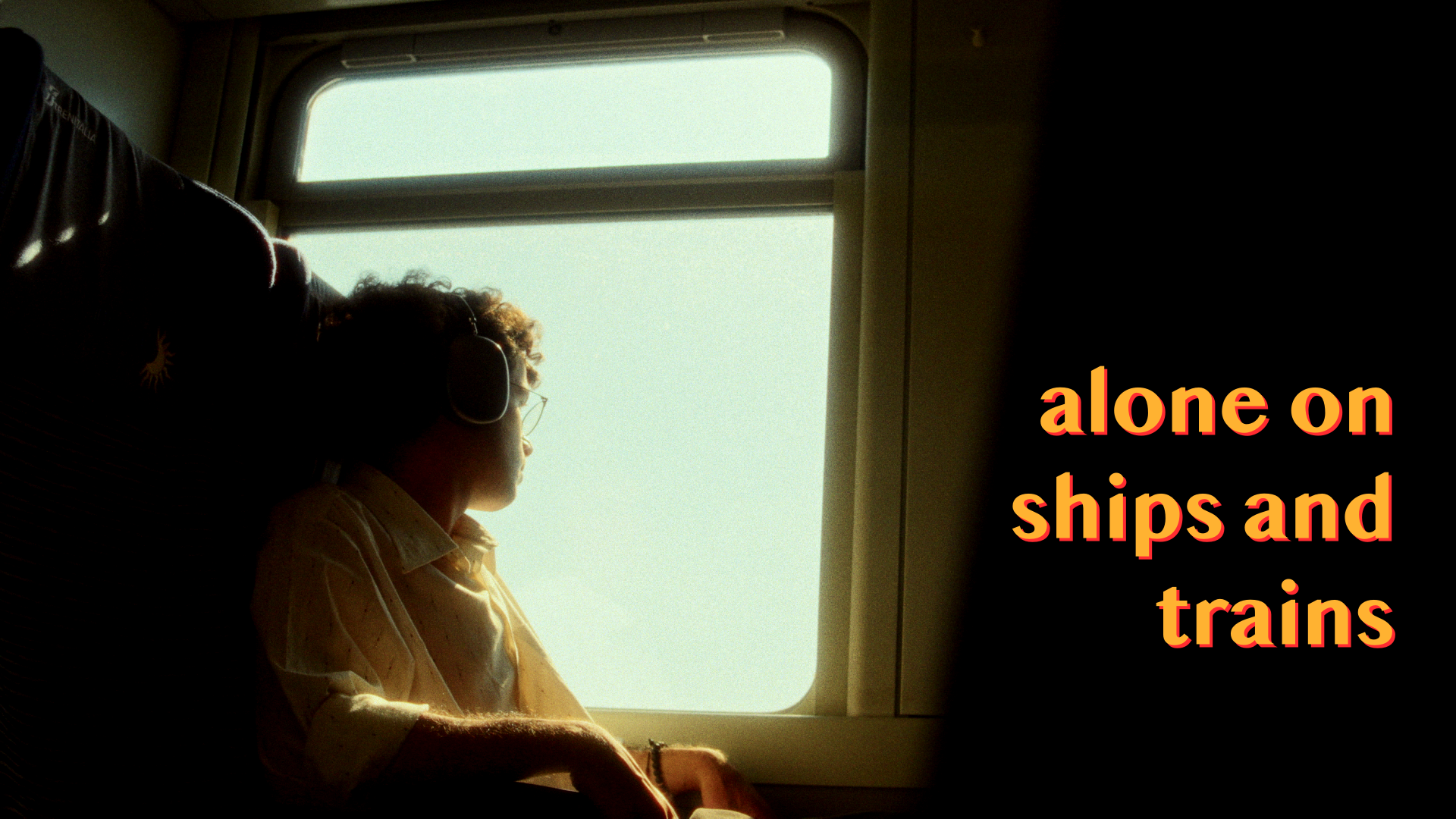 Person wearing headphones looking out a train window, with text "alone on ships and trains" overlayed.