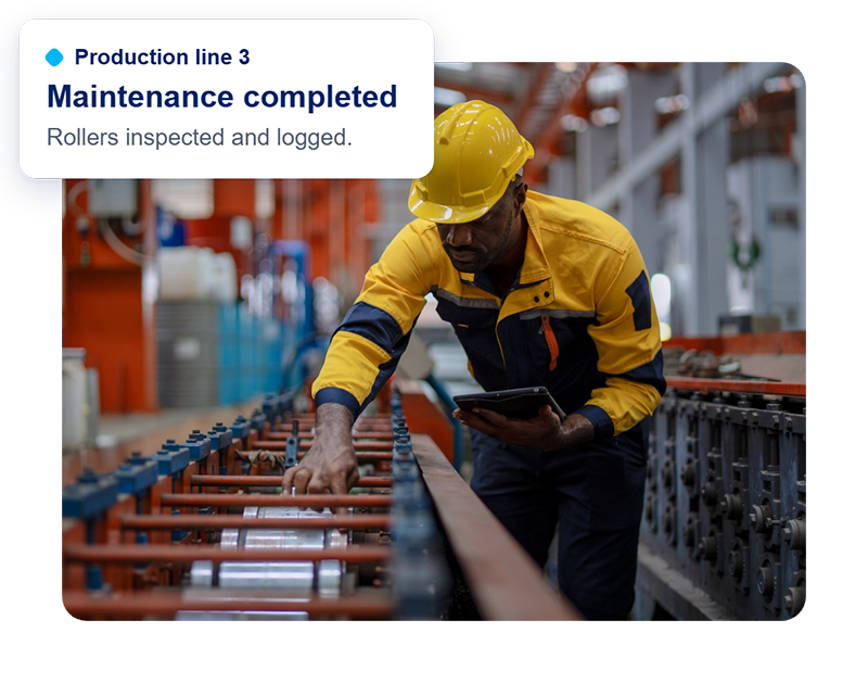 Technician in a hard hat checks a production line with a tablet. A card shows maintenance completed on Production line 3.