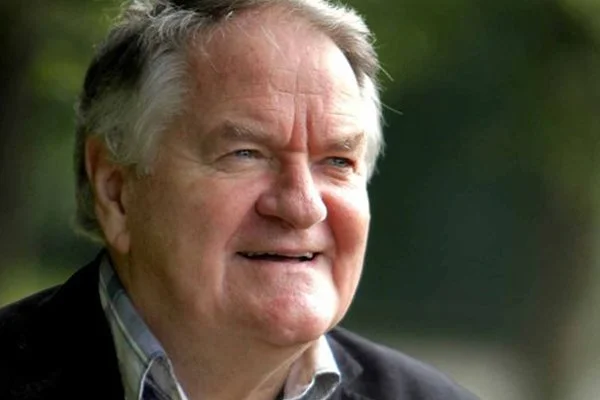 Dafydd Iwan, in a checkered shirt and dark jacket outdoors.
