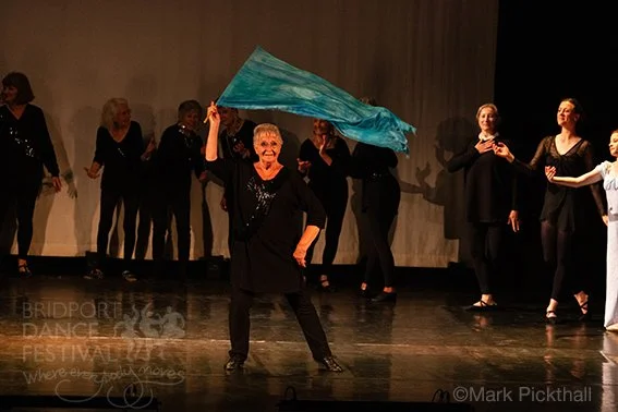 MyBallet performing on stage at Electric Palace. Dancers aged 20 - 80+. Annie Gordon solo dance with silk flag in 'Dance of the Knights'
