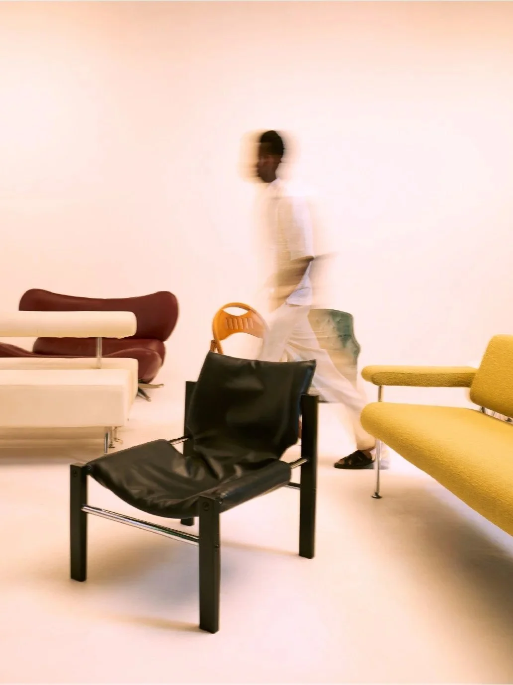 multicoloured chairs arranged around a figure in motion