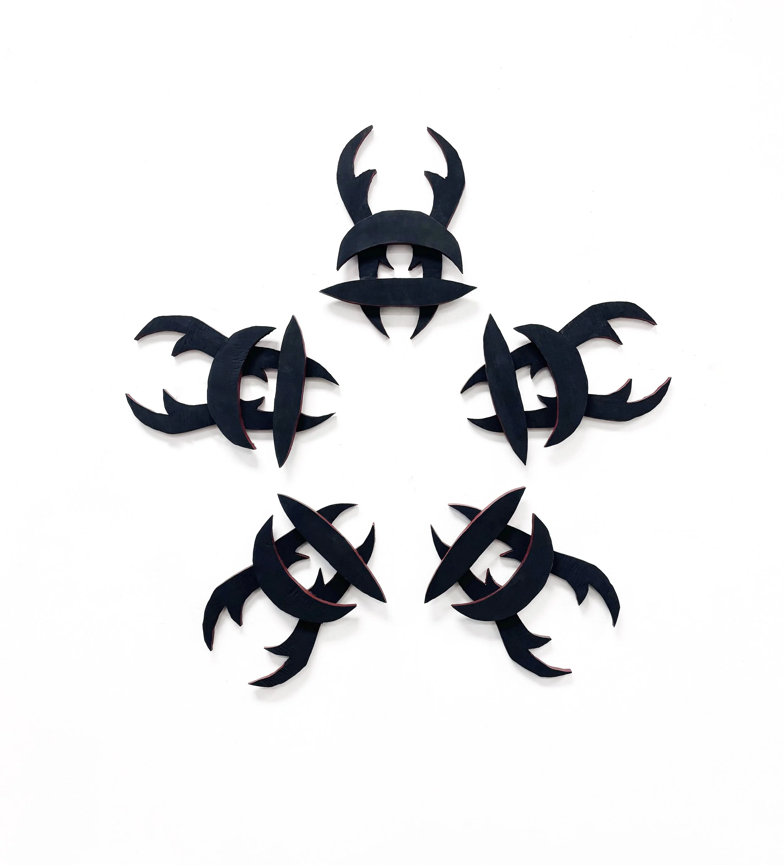 Experimenting with radial symmetry, I created repetitive, abstracted forms to create an interesting wall piece. 
(materials: wood)