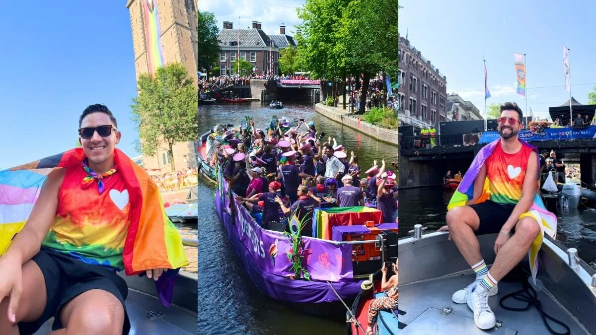 Gay couple enjoying Amsterdam WorldPride on the canals surrounded by LGBTQ+ Pride celebrations