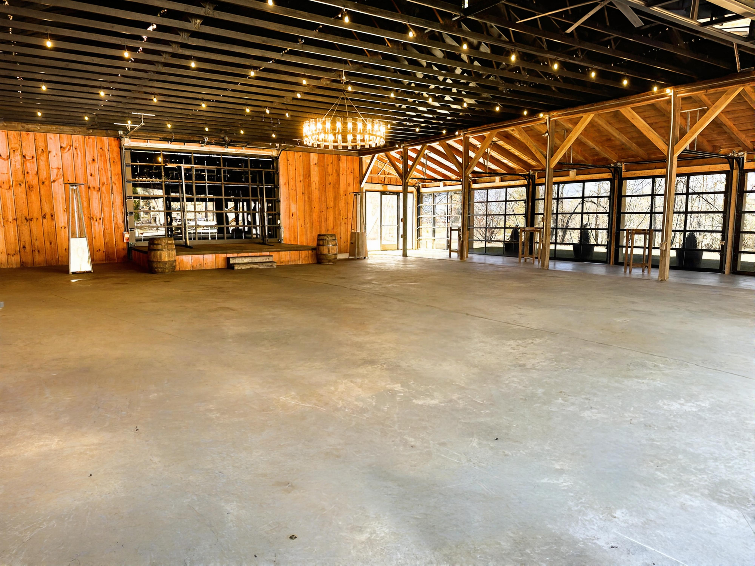 Barn wedding event venue, chandelier, roll up glass doors, string lights, Mountain wedding venue, Asheville Wedding event venue, Brevard Wedding event venue