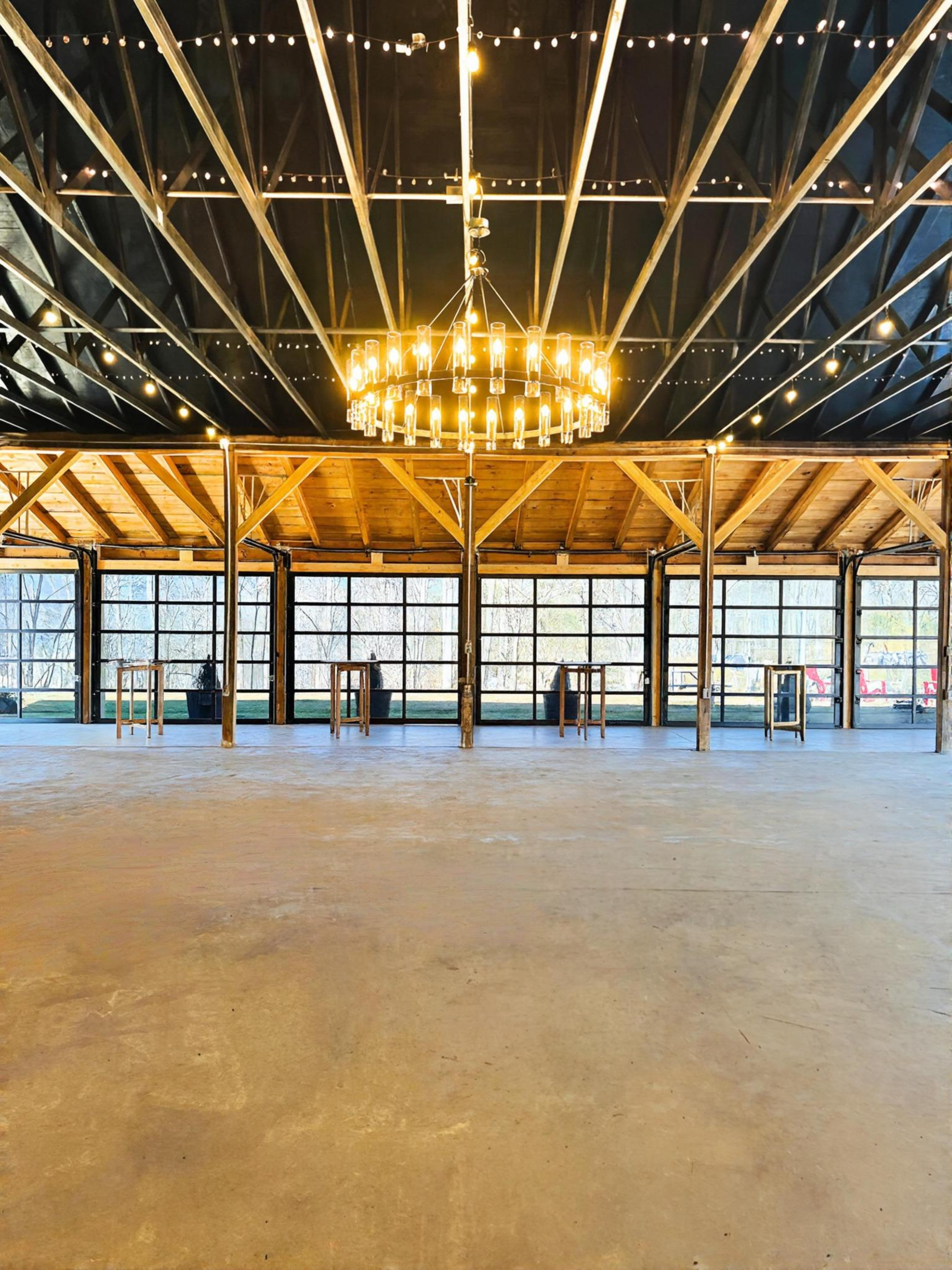 Barn wedding event venue, chandelier, roll up glass doors, string lights, Mountain wedding venue, Asheville Wedding event venue, Brevard Wedding event venue