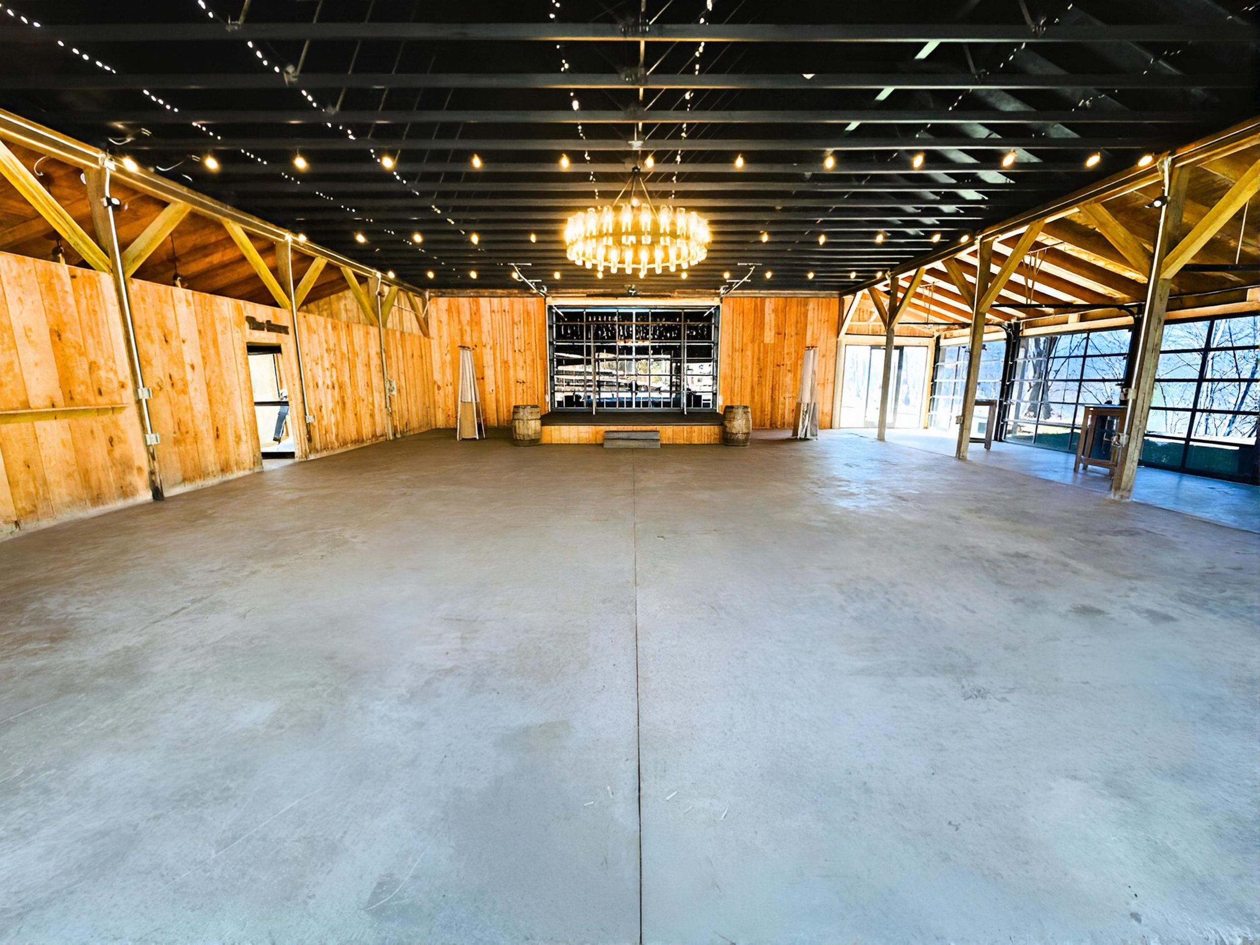 Barn wedding event venue, chandelier, roll up glass doors, string lights, Mountain wedding venue, Asheville Wedding event venue, Brevard Wedding event venue