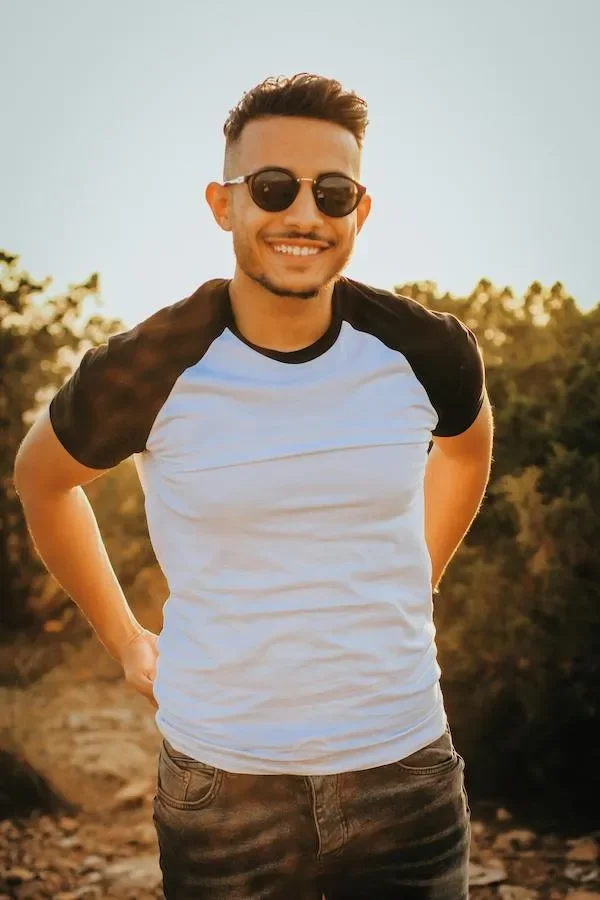 a man smiling with sun glasses on