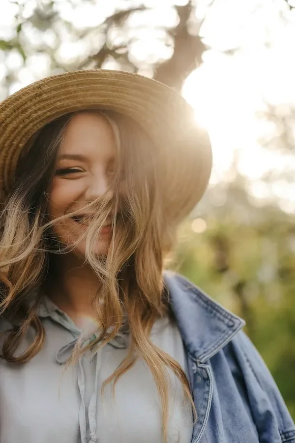 a happy woman with a hat on