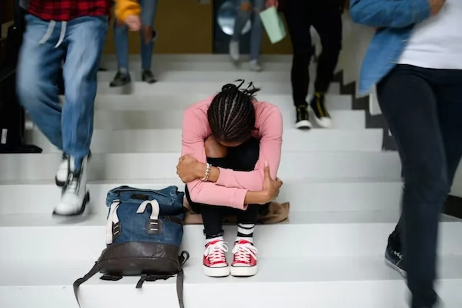 A university girl crying on stairs