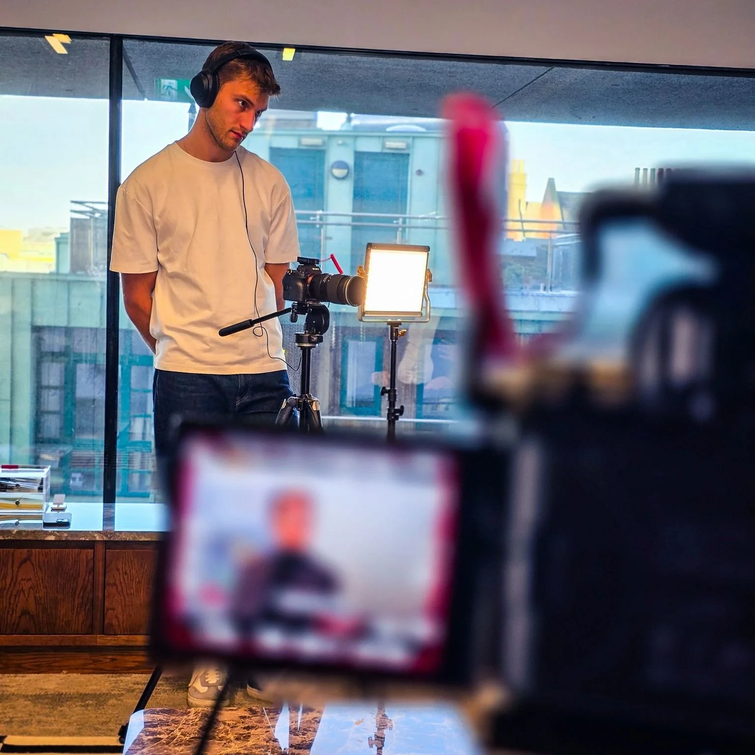 James filming a talking-head interview as part of a corporate storytelling video.