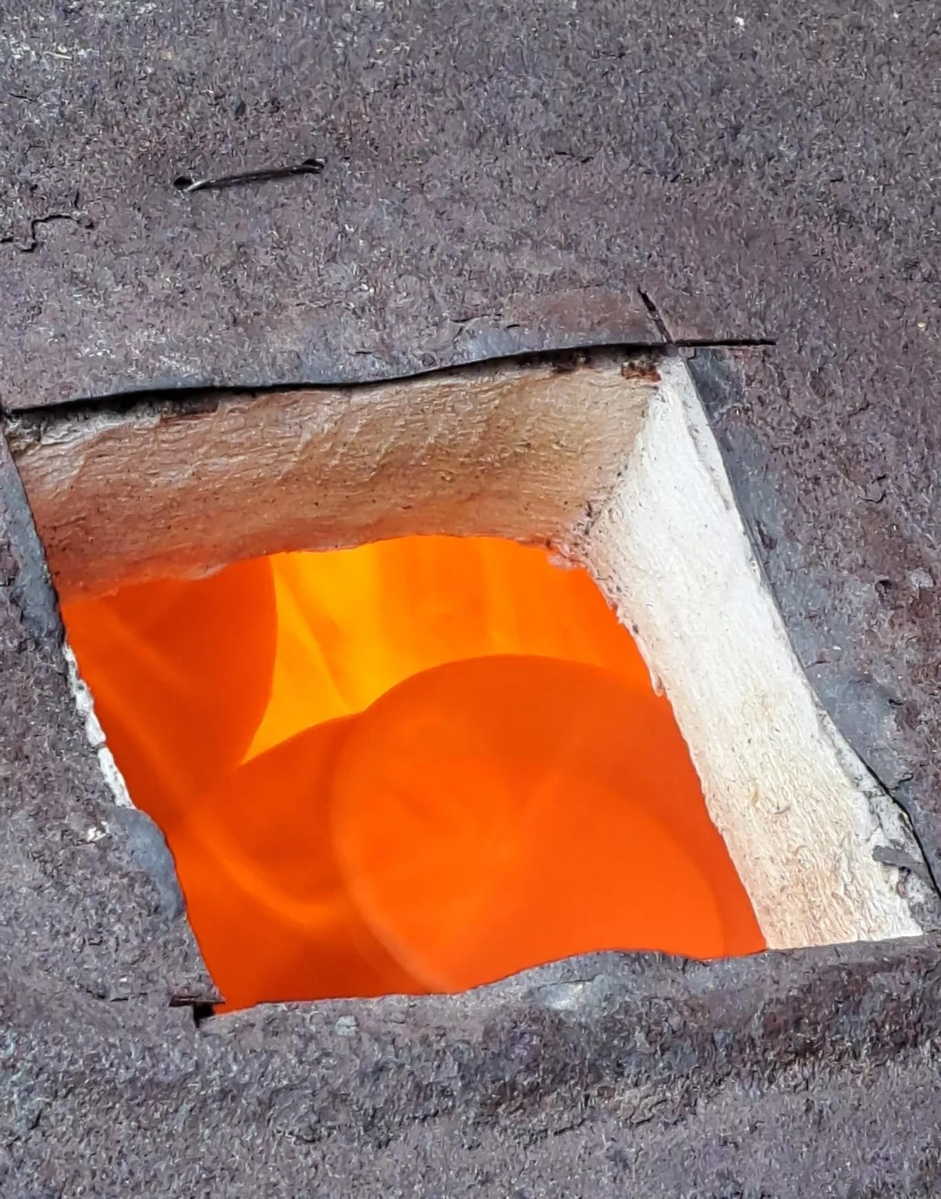 look down into raku kiln at red hot pots