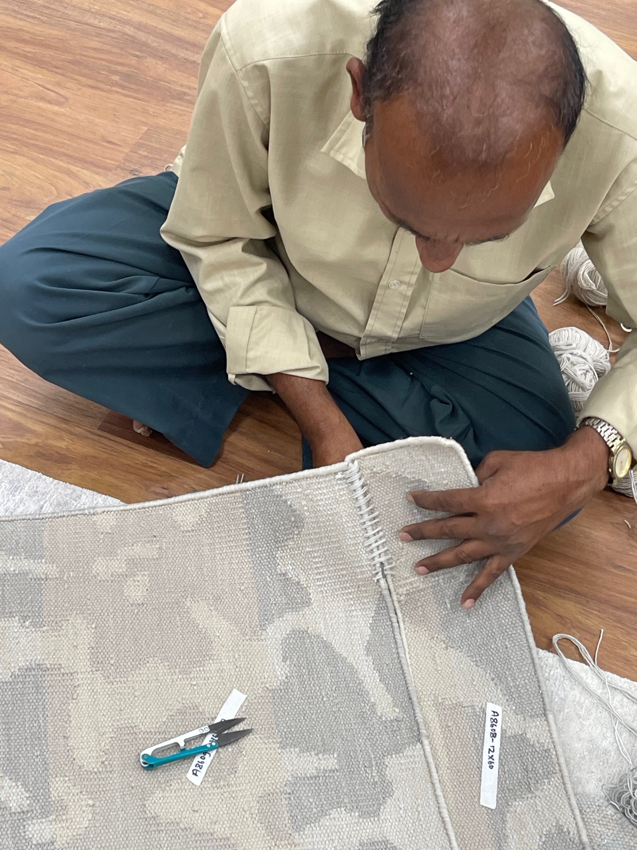 Production hand stitching flatweave.jpg