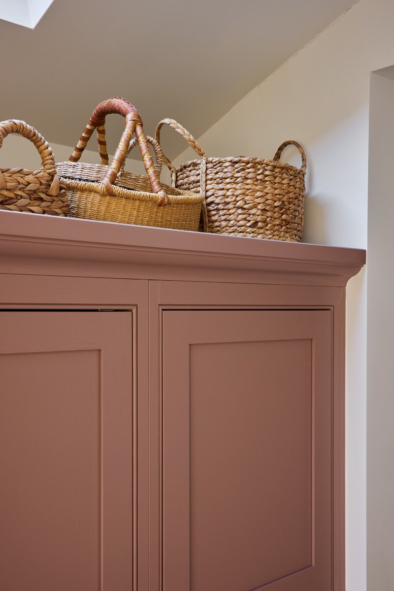 Bespoke soft pink kitchen larder cabinetry with layered textures in London