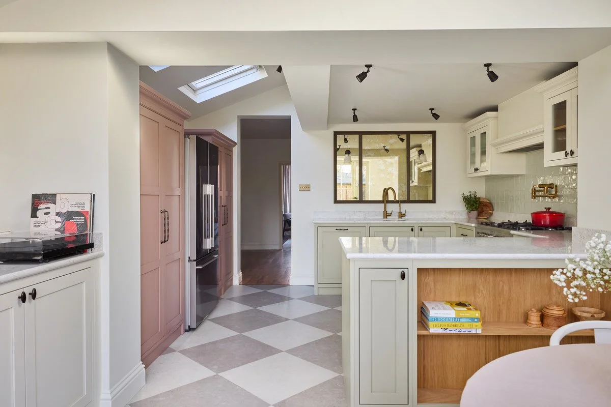 Chequerboard porcelain floor tiles adding character to a soft London kitchen design