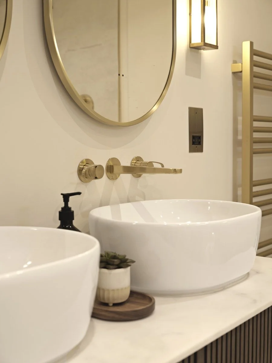 Luxury hotel bathroom featuring freestanding bath and marble-effect surfaces