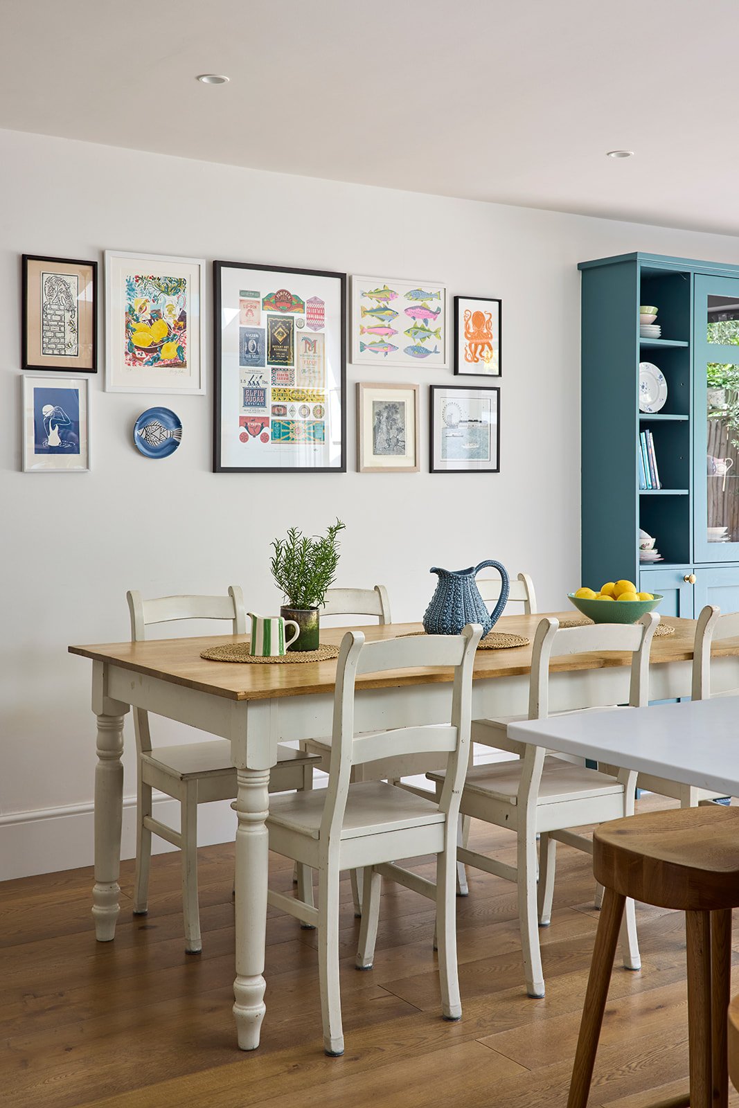 dining table with a farm style chairs pendant lights teal vintage cottage display cabinet
