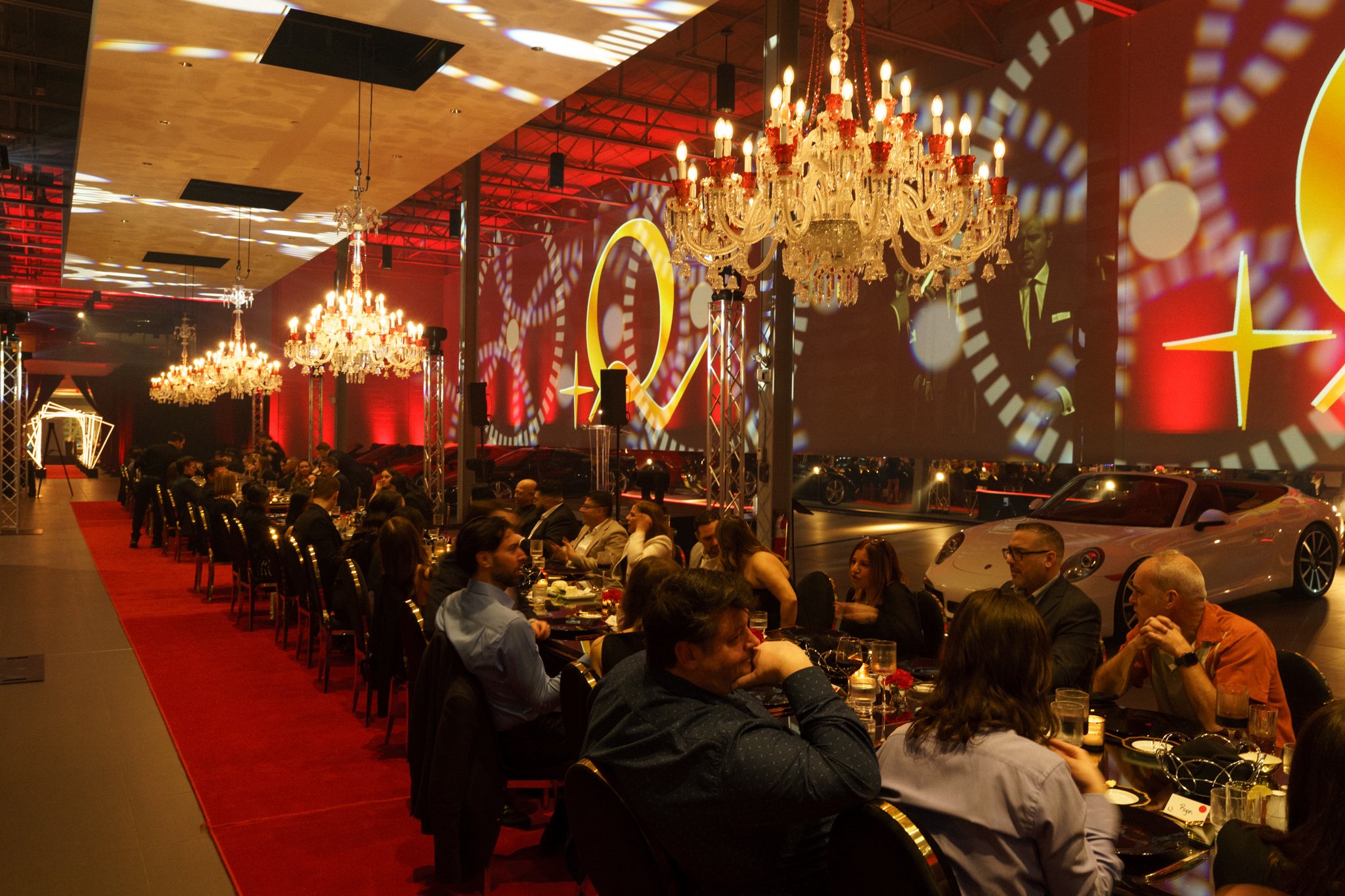 Team members networking during annual corporate gala at Automobiles Etcetera in Montreal, photographed by SquareLoop.