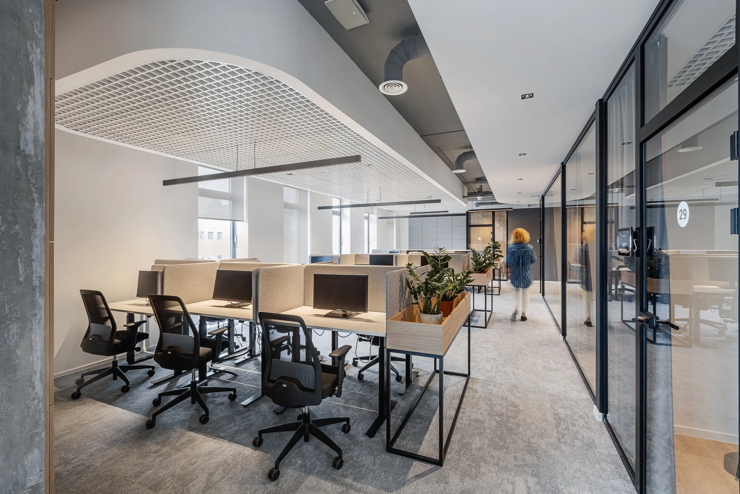 cozy and modern working area in office interior with innovative acoustic ceiling 