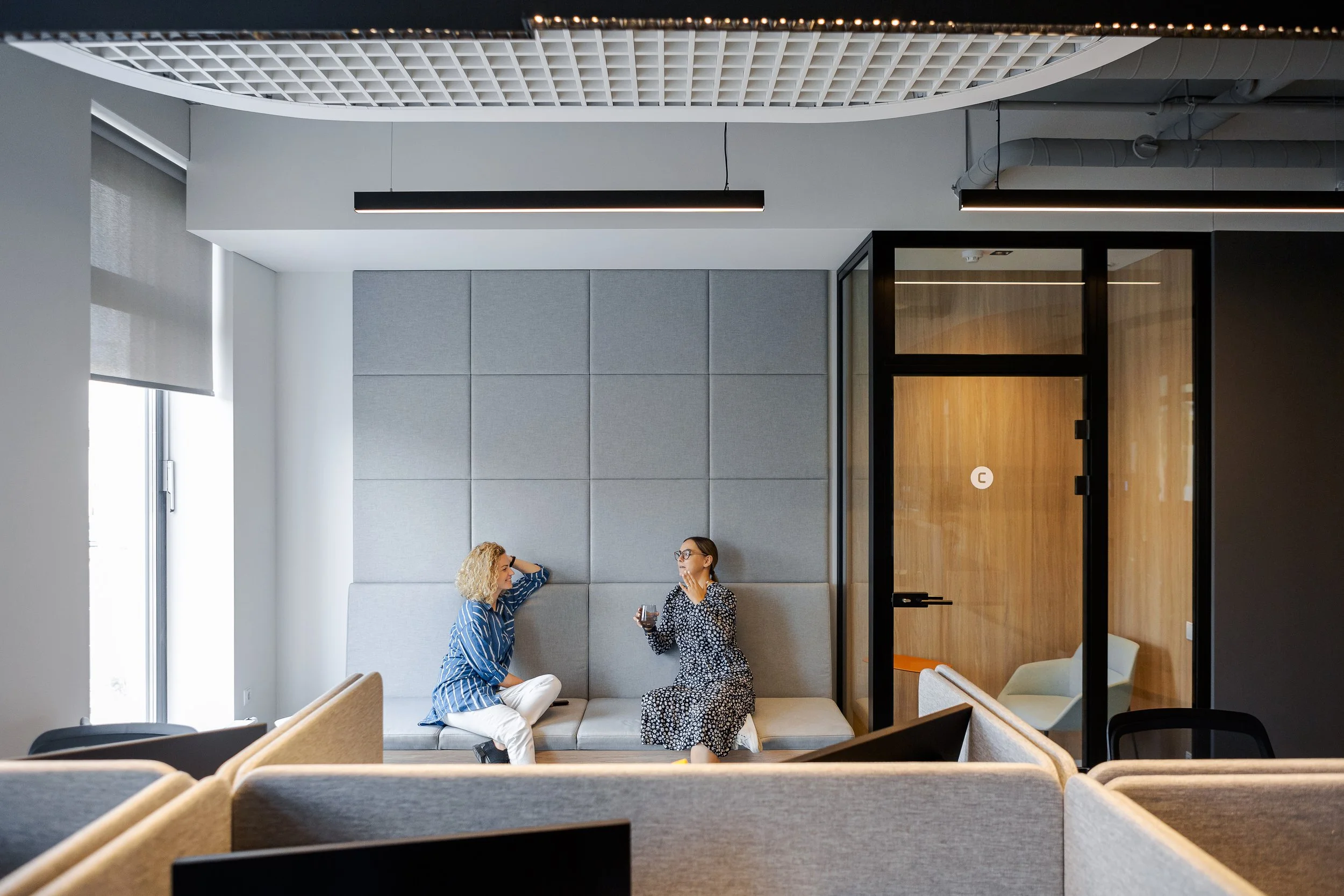 Cozy and soft seating and chilling area made from acoustic fabric in office interior 