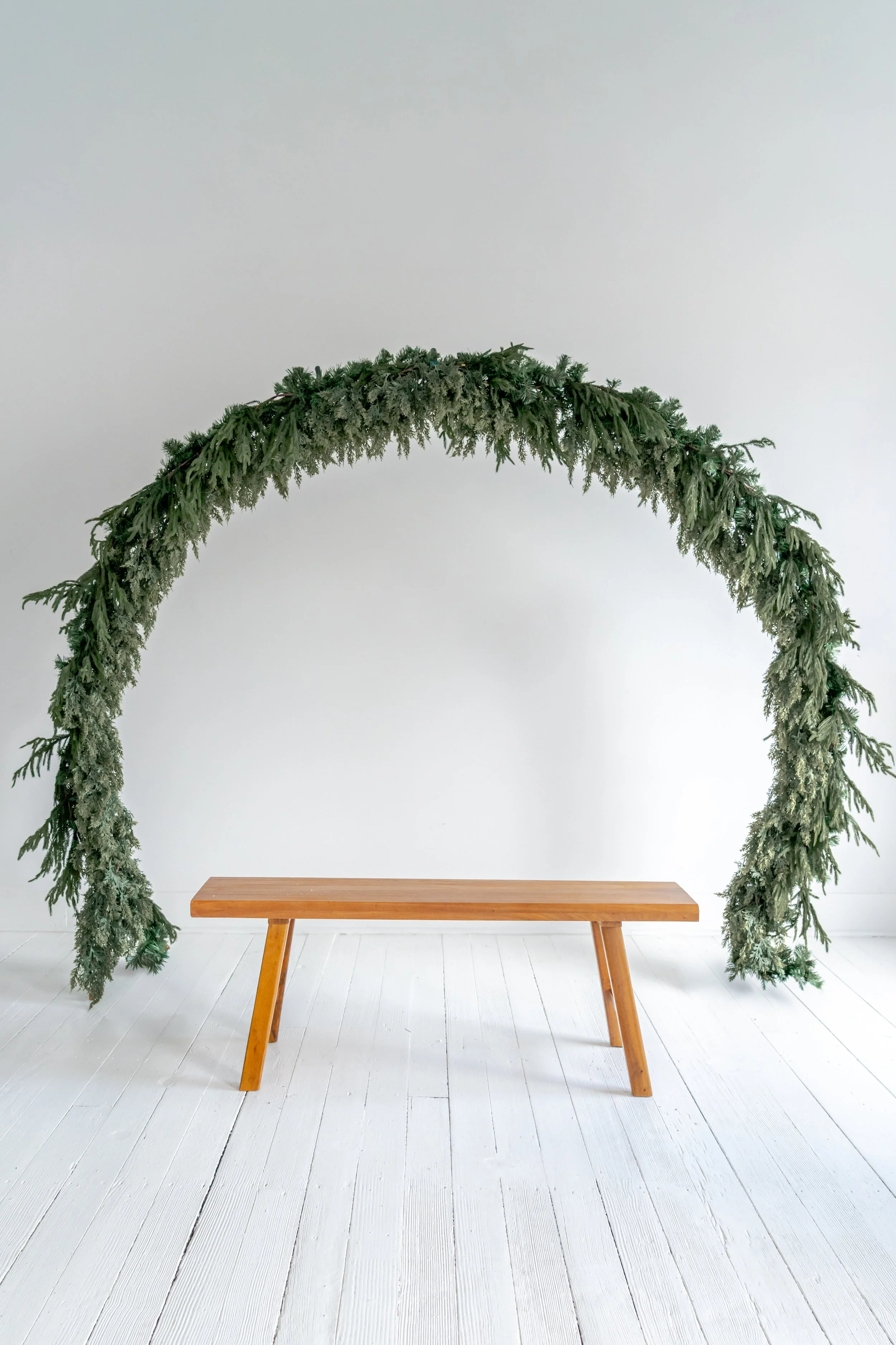 minimalistic enlarged wreath with wooden bench Christmas or holiday photoshoot set