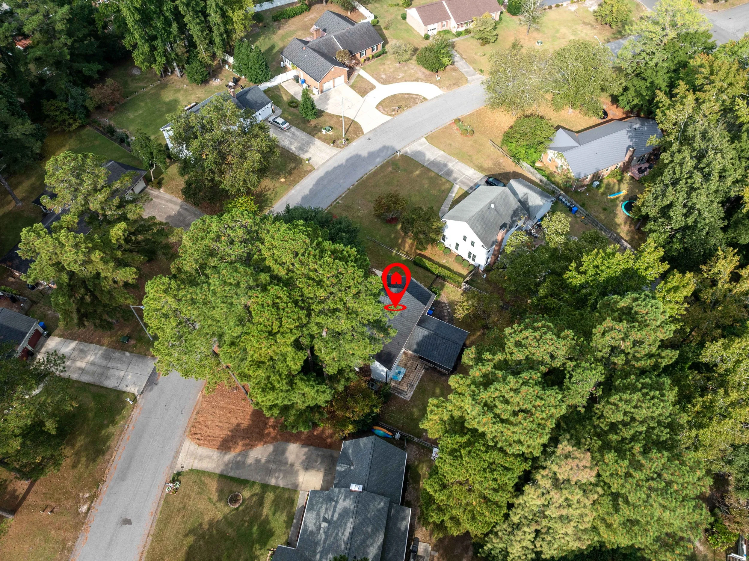 Aerial view of a residential neighborhood showing property location, lot boundaries, and surrounding homes