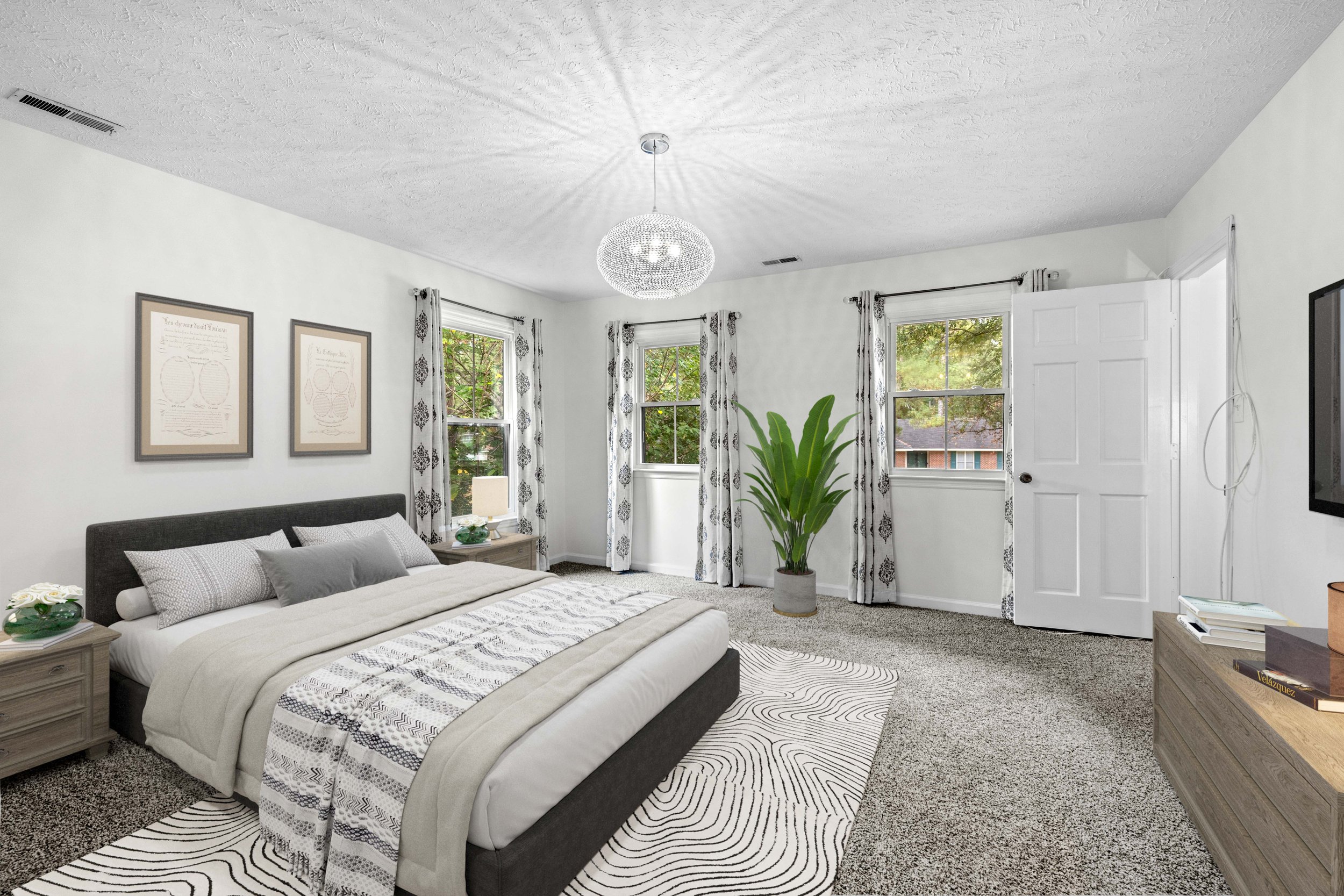 Primary bedroom with neutral decor and natural light in a residential home in Fayetteville NC