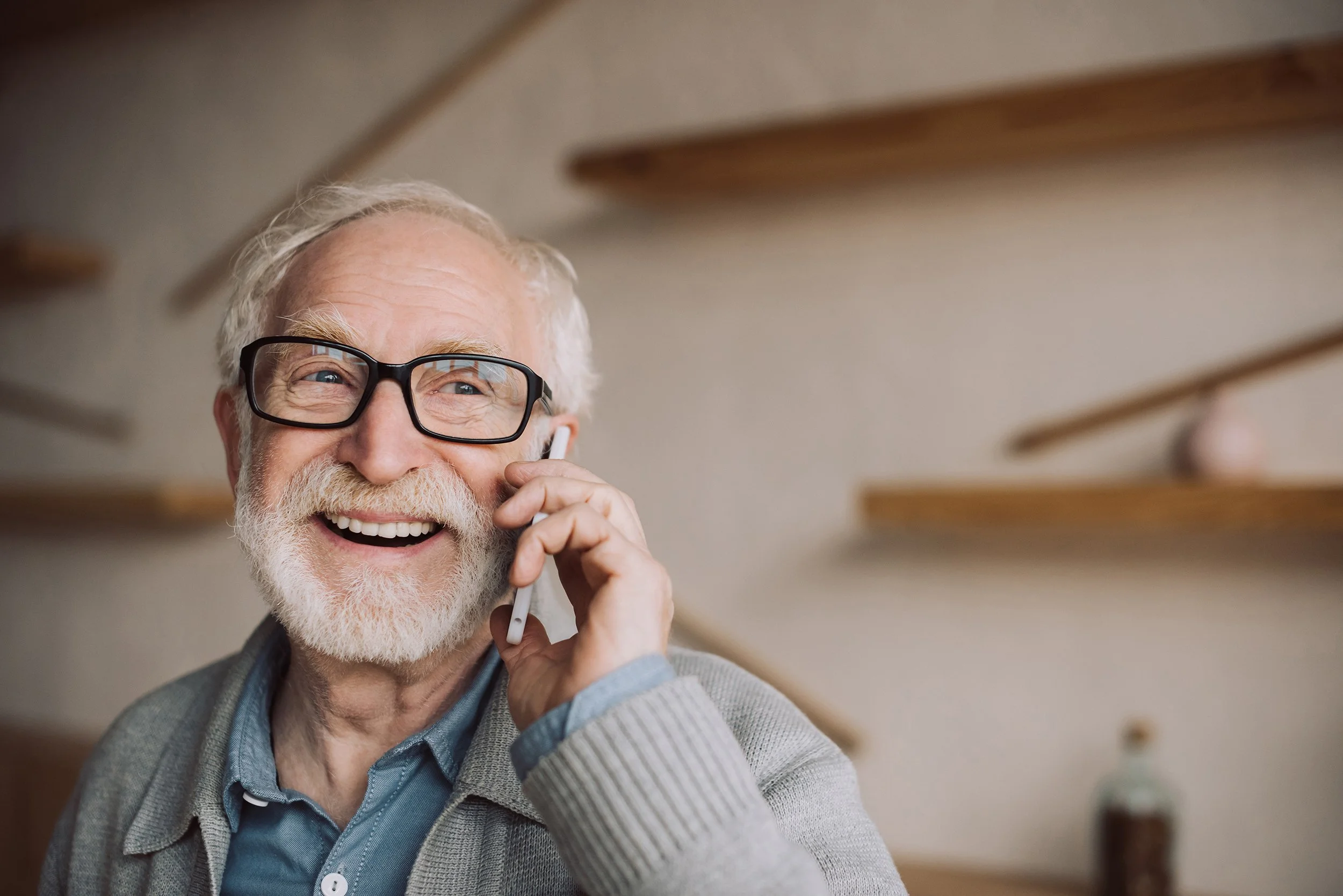 An older man talks on the phone. Contact us today to schedule a no-pressure exam and get more information on how oral appliances for snoring may help.