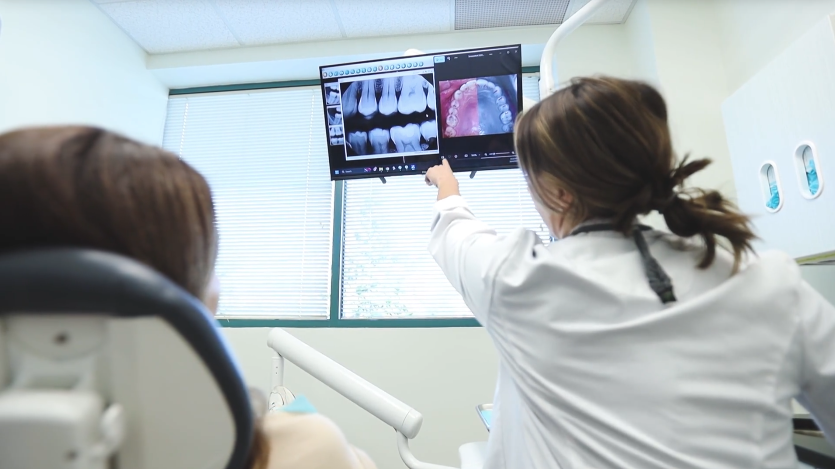 A patient reviews pictures of her teeth with a dentist at Kirkwood Family Dental Contact us today to book a no-pressure dental exam. We can't wait to meet you!