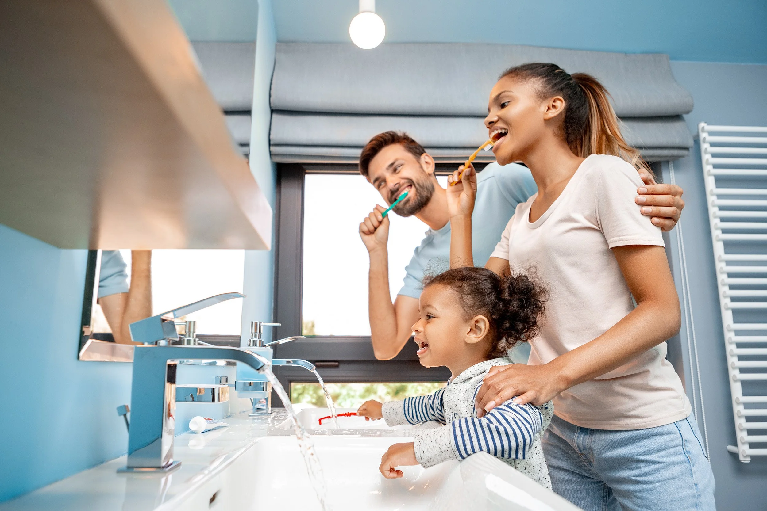 A family brushes their teeth together. Prescription fluoride toothpaste has 3x the strength of standard options. Learn who benefits most, how to use it correctly, and what to expect from your dentist.