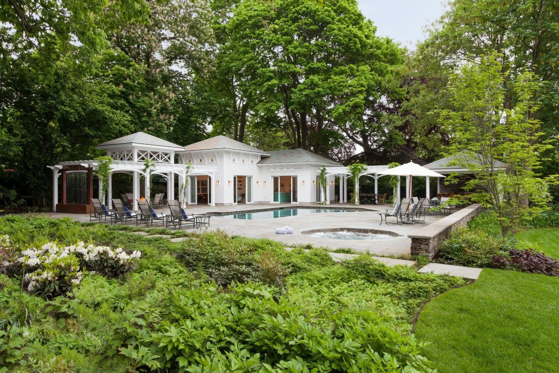 Landscape design with retaining walls and poolside lounge in Cambridge, MA