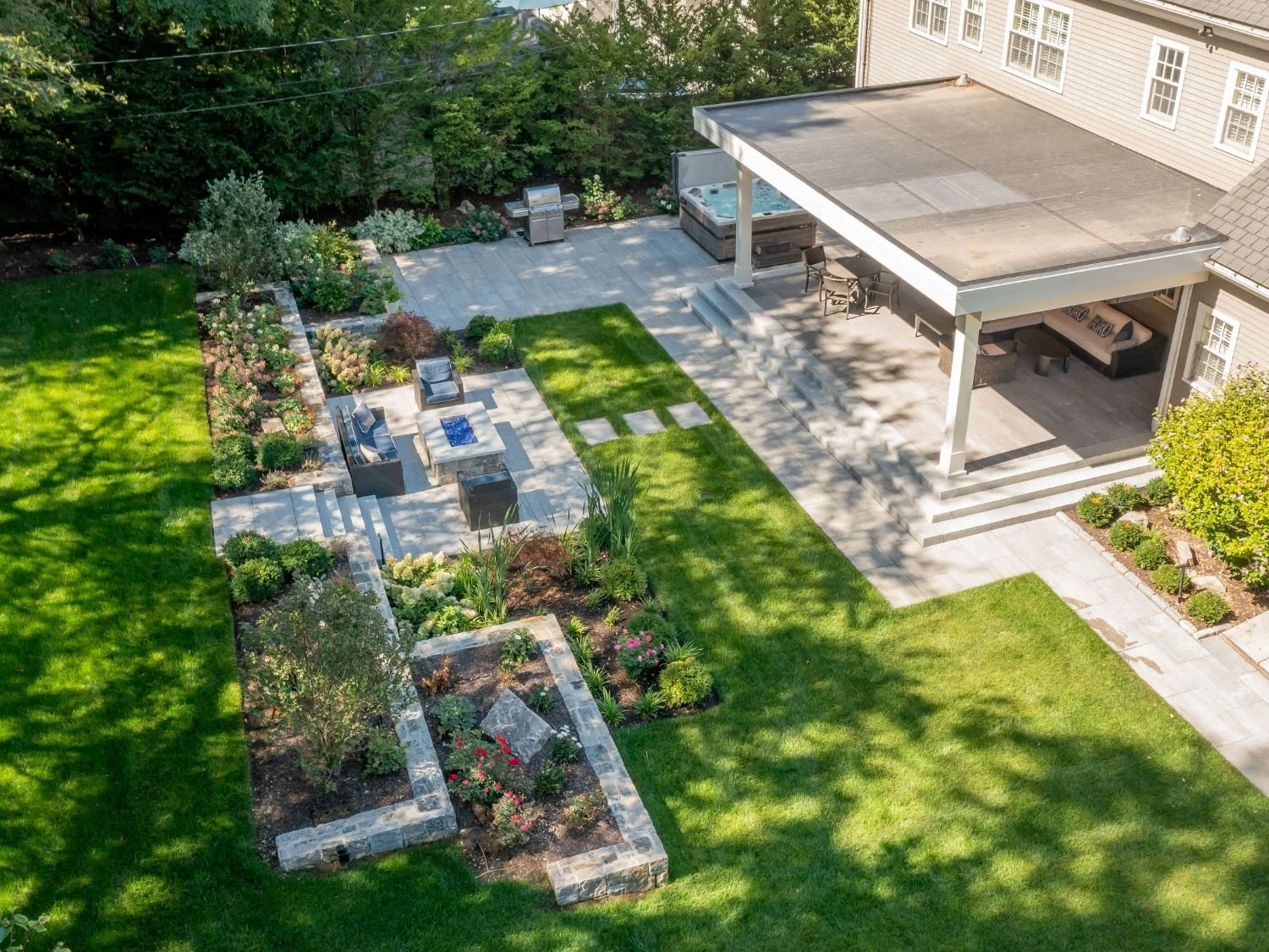 Aerial view of backyard bluestone patio and outdoor living space in Arlington, MA
