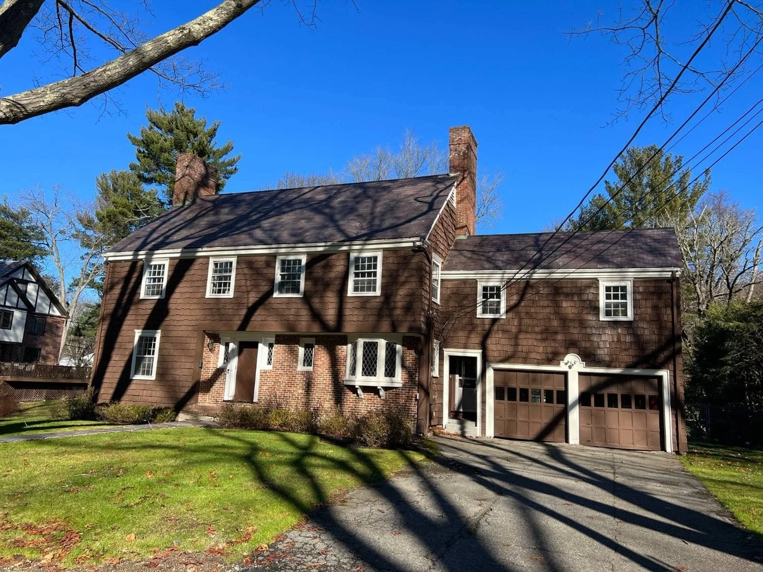 A Raised Bluestone Patio With Integrated Covered Area and Custom Granite Walls in Arlington, MA