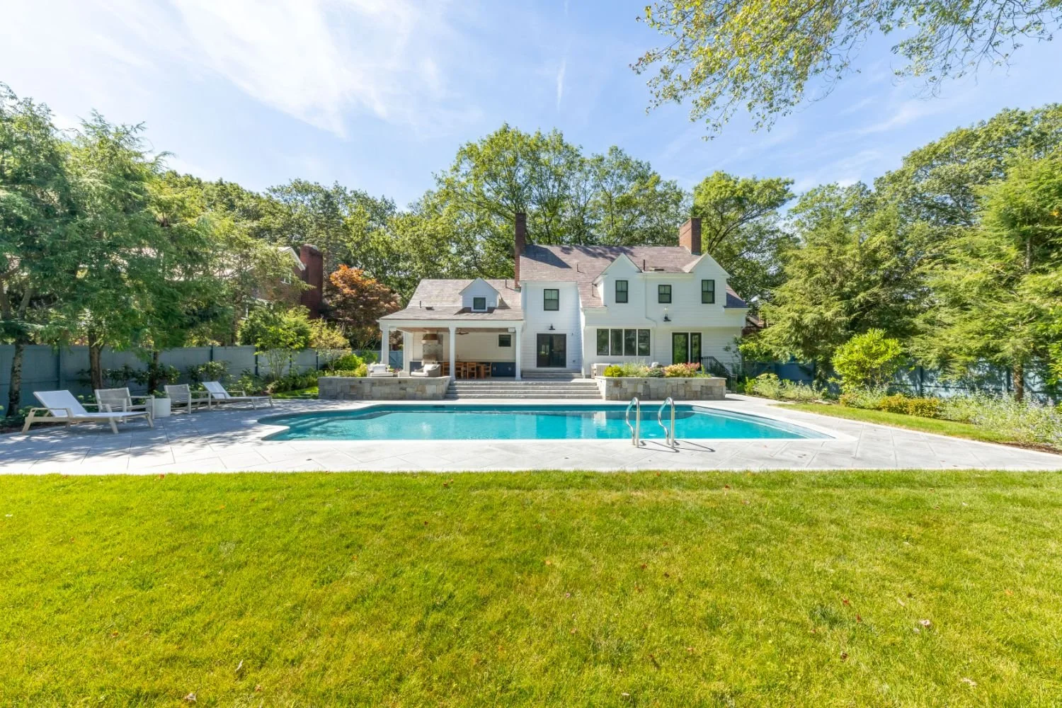 Backyard pool renovation with expanded outdoor living space in Newton, MA