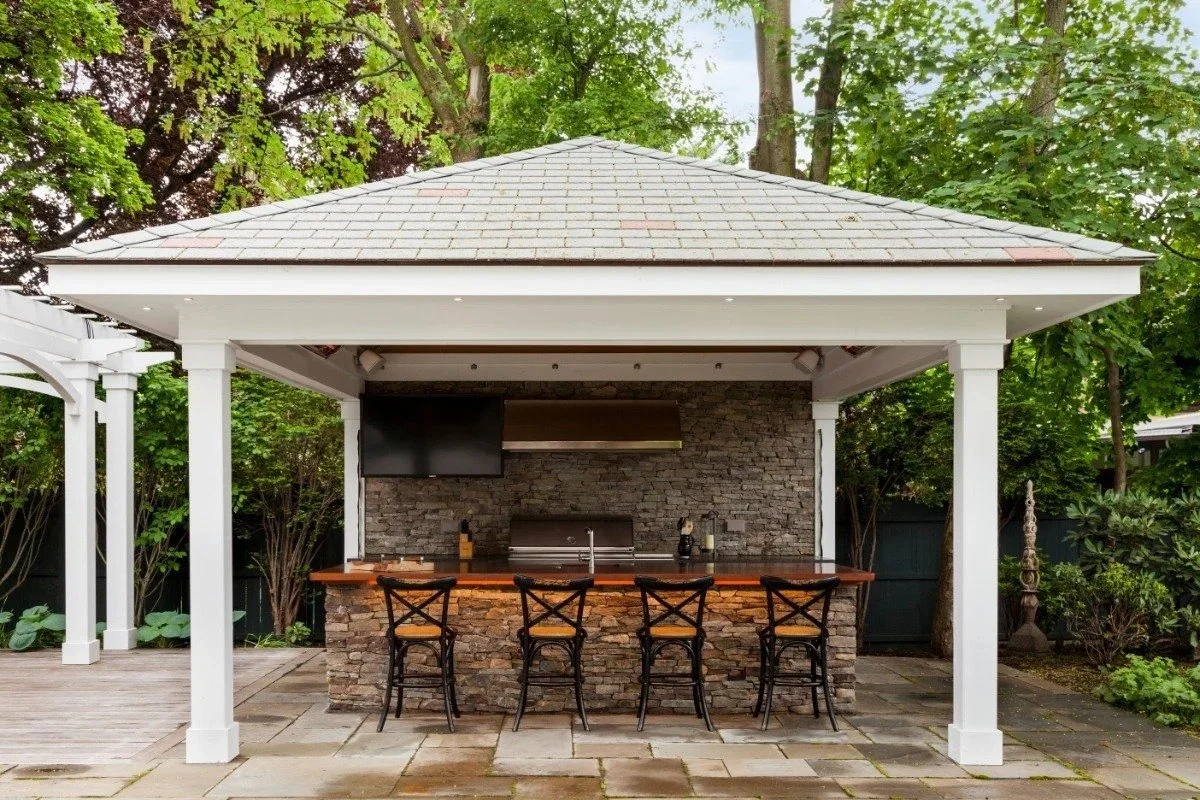 Covered outdoor kitchen and bar pavilion with stonework in Cambridge, MA