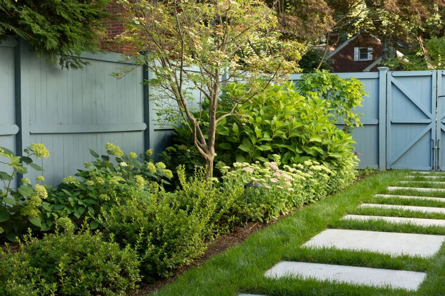 Detailed stonework along the pool deck and patio edge in Newton, MA