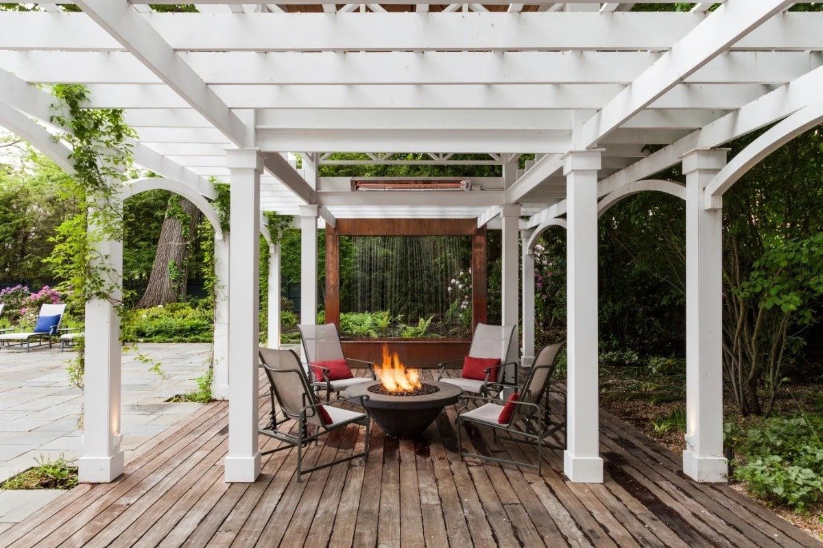 Fire pit lounge under white pergola on bluestone patio in Cambridge, MA